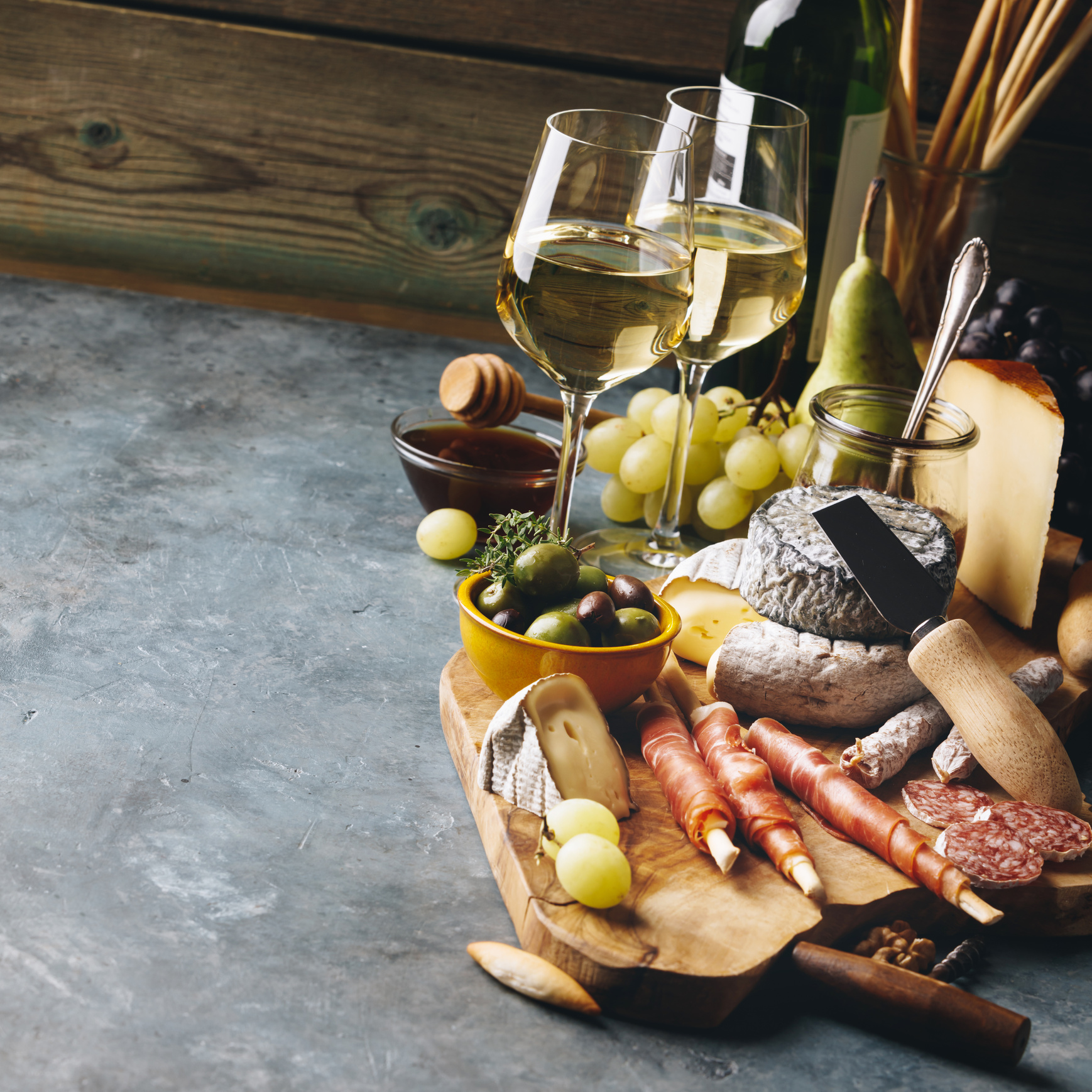 White Wine with Charcuterie Assortment on the Stone Background
